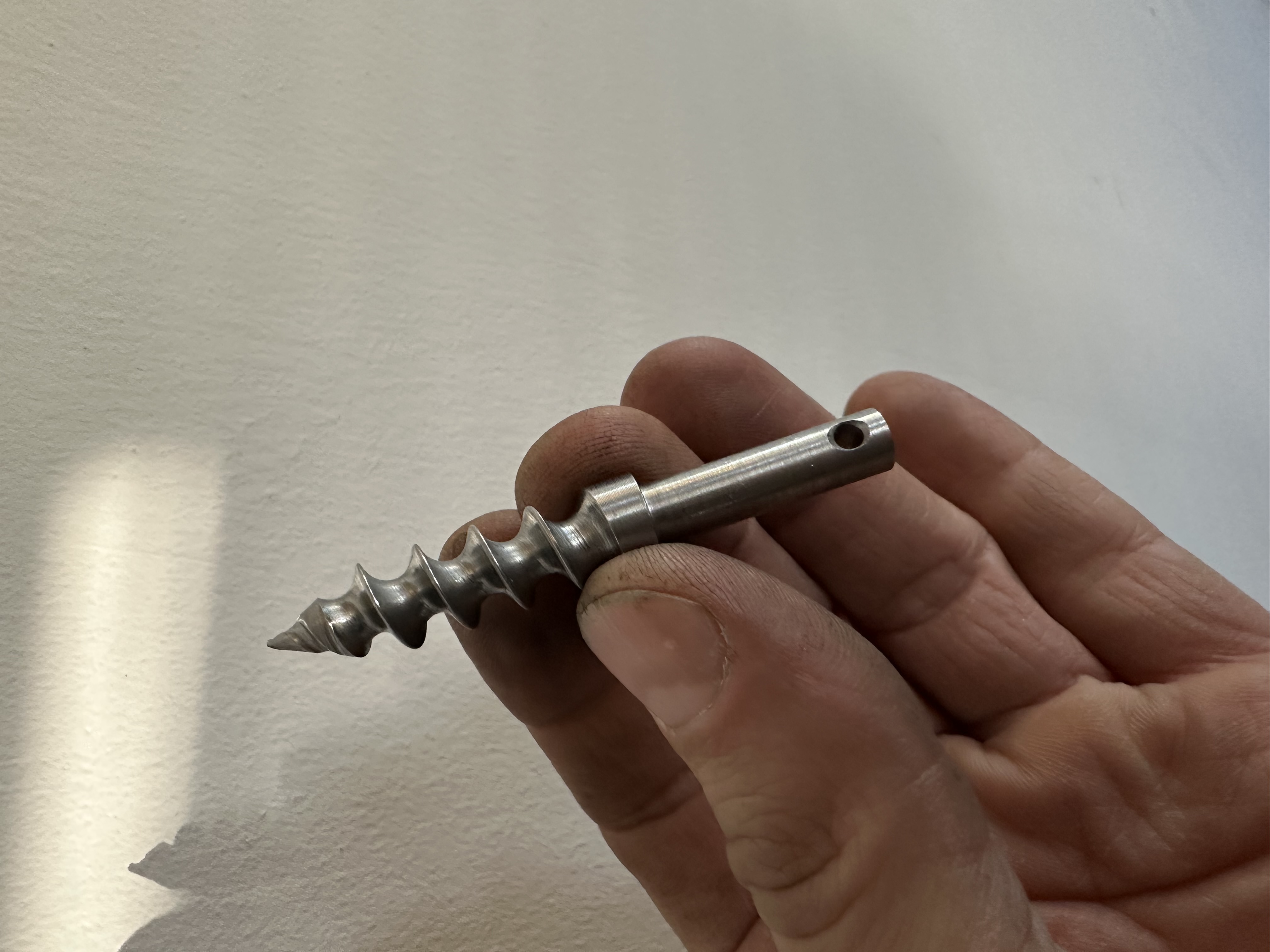 Nahaufnahme eines maschinell bearbeiteten edelstahlartigen Schraubenbauteils